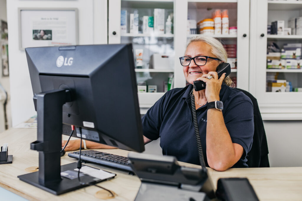 Receptionist talking to client on phone